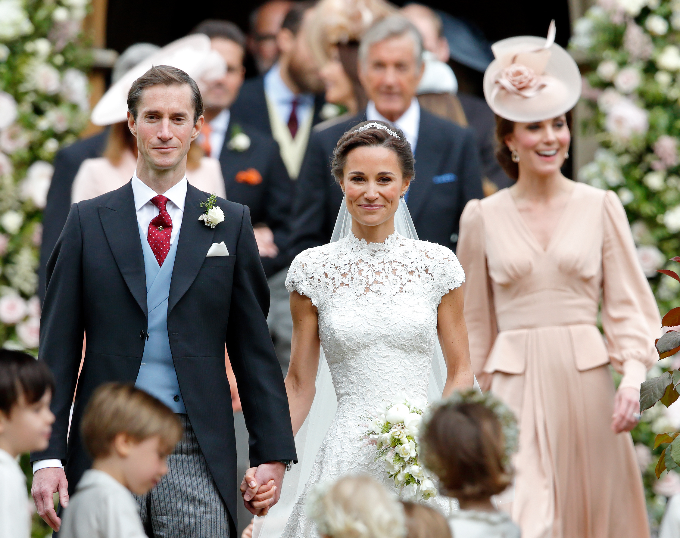 Pippa and James Matthews on their wedding day with Princess Kate behind them