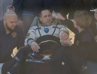 Russian cosmonaut Anton Shkaplerov plucks grapes from a bowl after returning to Earth on a Soyuz spacecraft. It was his first meal on Earth after a 168-day mission to the International Space Station.