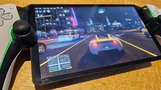 PlayStation Portal review; a large screen on a handheld games console, on a wooden table