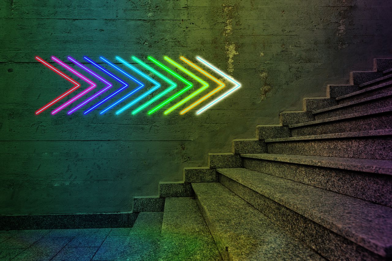 neon arrows pointing to staircase