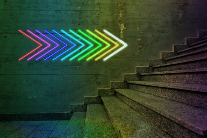 neon arrows pointing to staircase