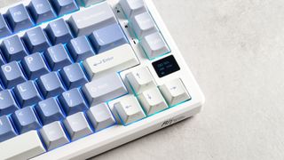 A Royal Kludge M75 wireless mechanical keyboard with blue keycaps