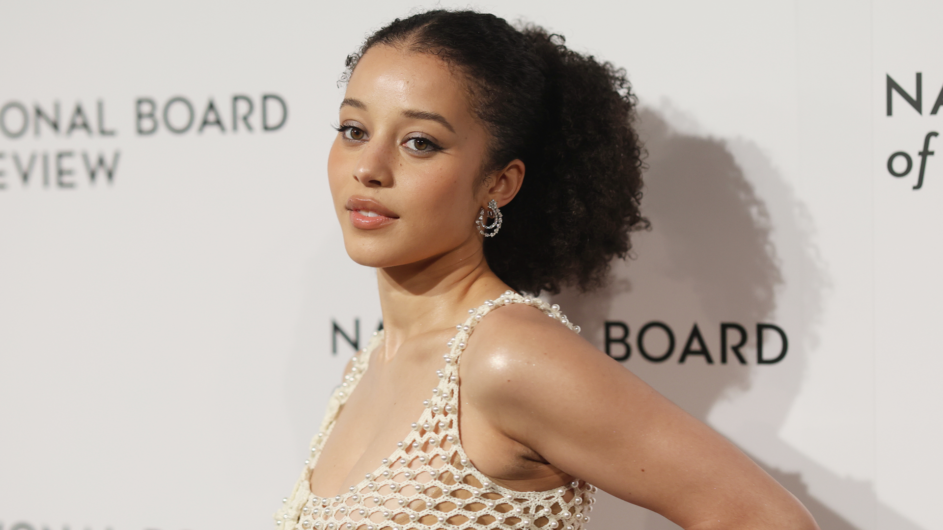 Chase Infiniti attended the National Board of Review gala in a fishnet ivory Oscar de la Renta dress