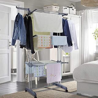 Grey tiered drying rack with clothes