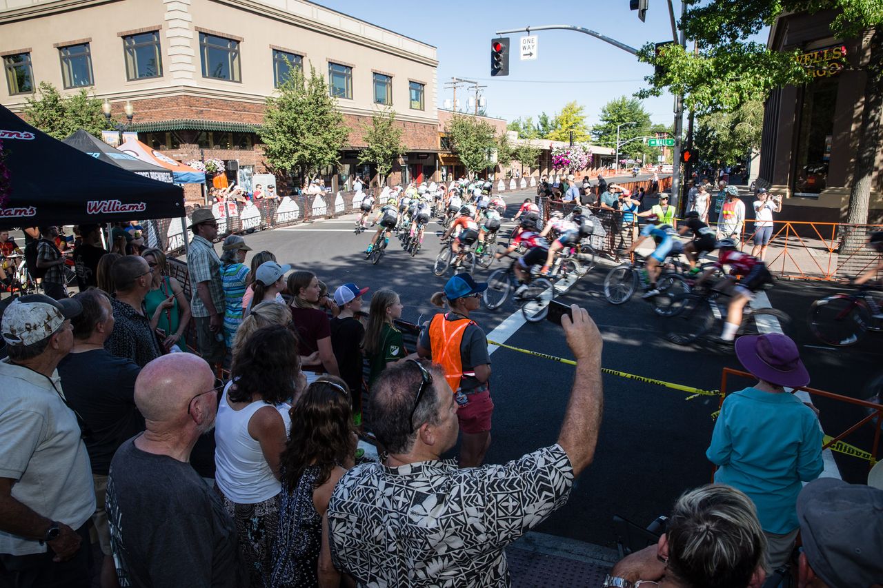 Crowds watch as the women hit turn one.