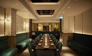 Diners settle into crushed emerald velvet banquettes