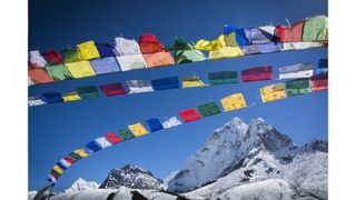 Colorful prayer flags above the Himalayas in Nepal