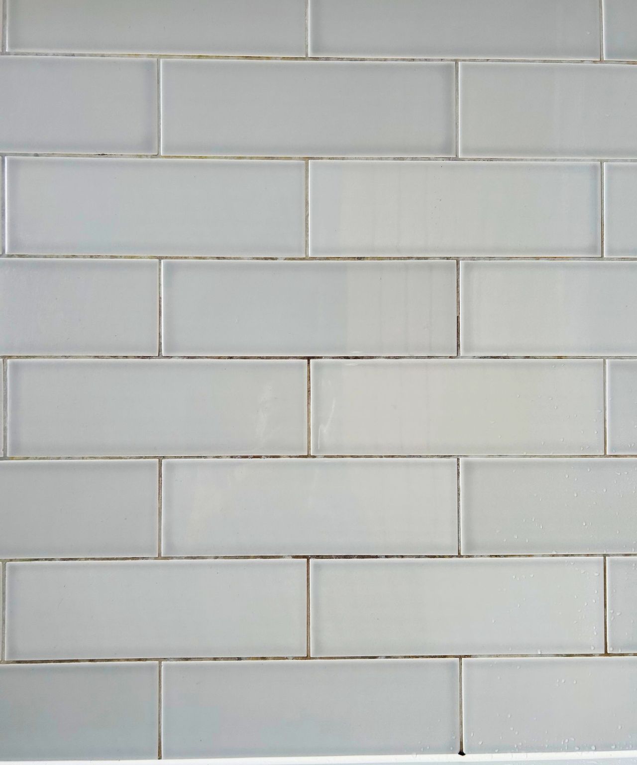 Soap scum, mold and grime had built up in gray tiles