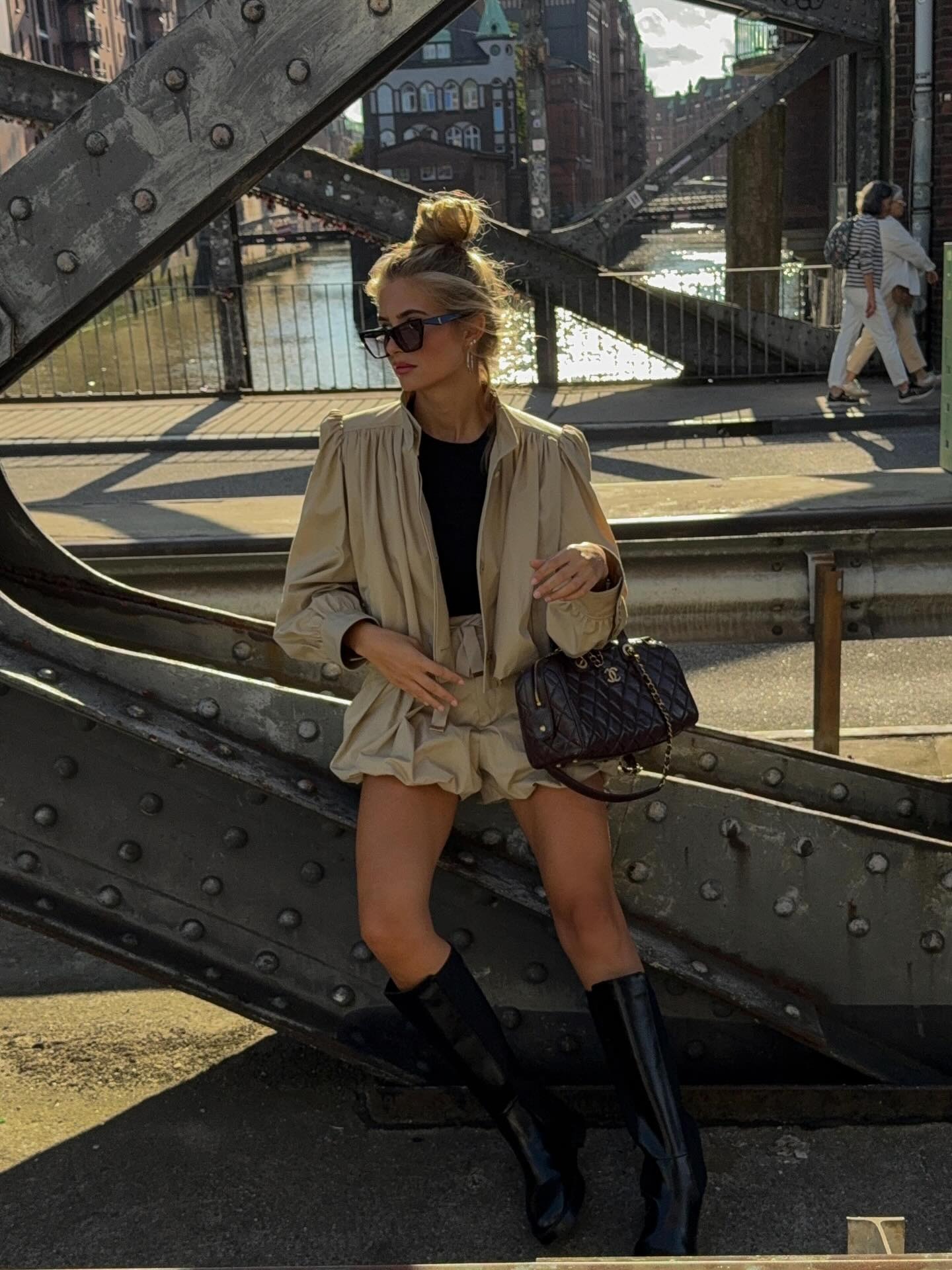 Fashion person Xenia Dont wears a boho fashion outfit. She wears a matching two piece set, black knee high boots and a black Chanel bag in a recent image from her Instagram
