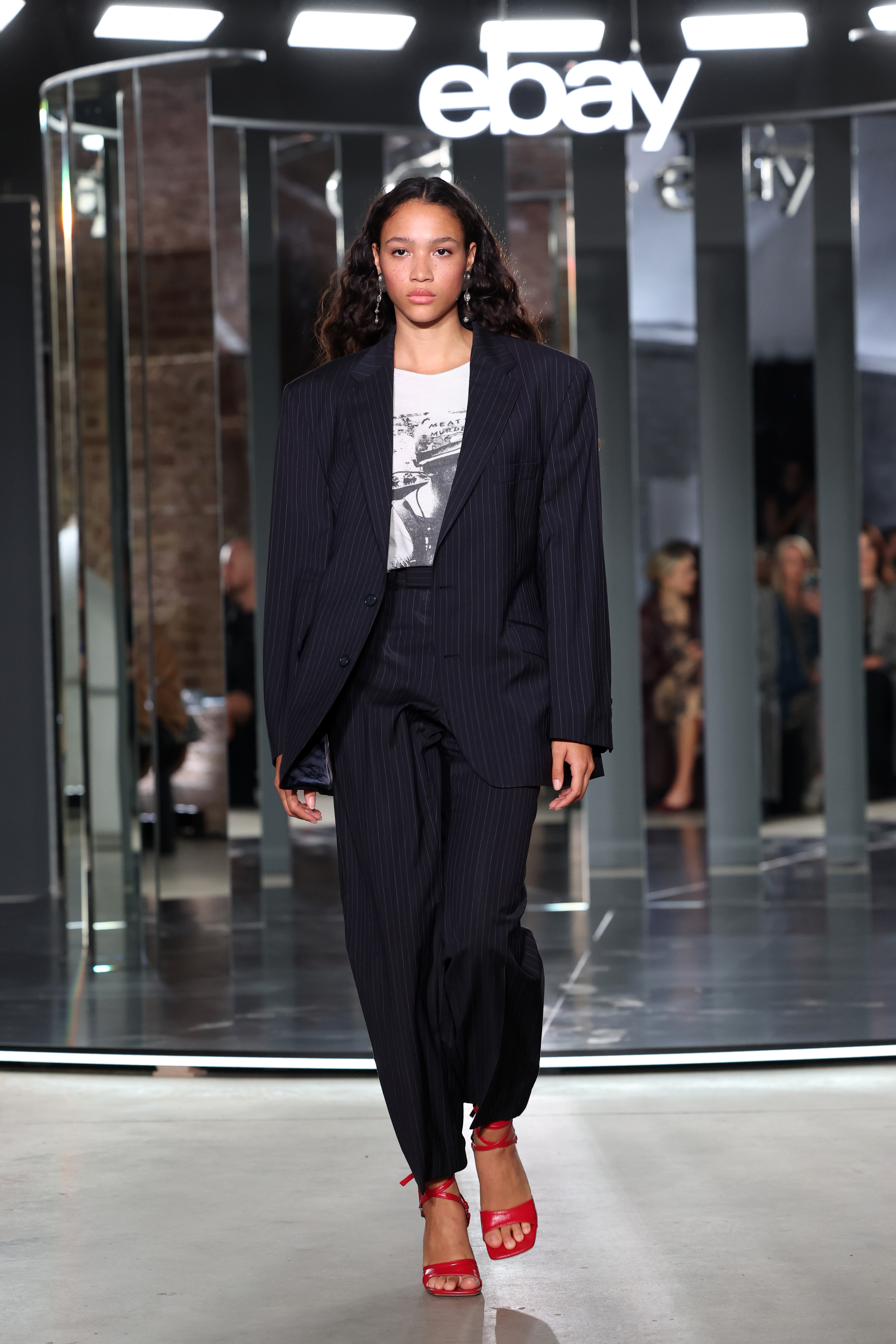 a model walks the ebay endless runway in an M&amp;amp;S suit