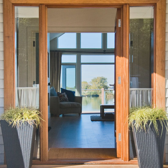house exterior with entrance door and lake view