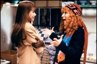 two women speak excitedly in a kitchen in the movie beaches