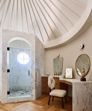 marble shower and curved vaulted ceiling cream walls