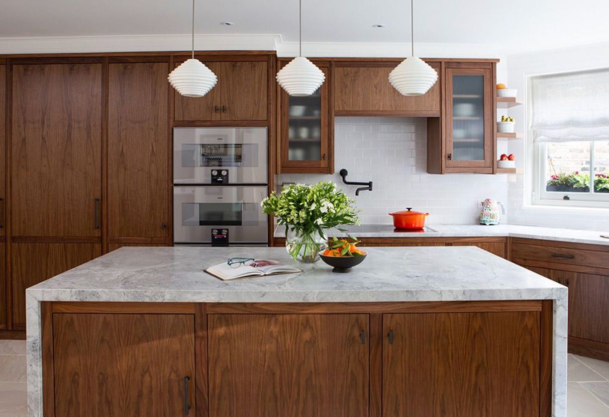 Kitchen with kitchen island and lighting above