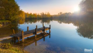 Wooden Jetty on a Becalmed Lake at Sunset by allou