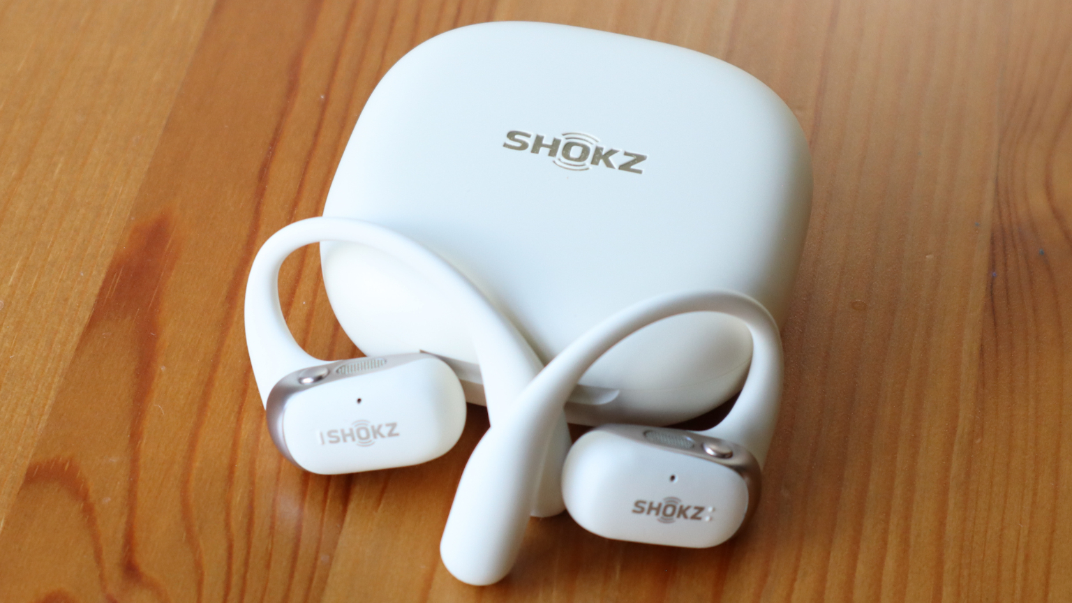 Shokz OpenFit 2 on a wooden table