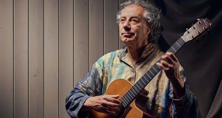 Pierre Bensusan is photographed with his beloved Lowden acoustic