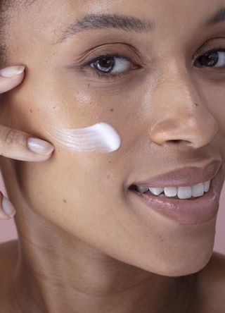 Woman applying eye cream