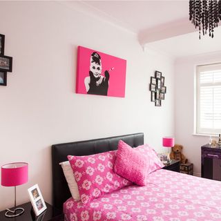 childrens room with girls bedroom and white wall with pink cushion on bed