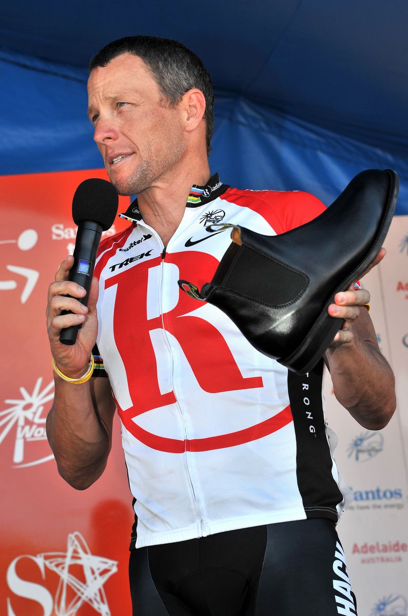 Lance Armstrong on the stage for the final time at the TDU showing his RM Williams to the crowd
