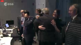 Scientists celebrate in a European Space Agency control room when they get the word that the Philae lander has successfully separated from the Rosetta spacecraft and is on its way down to the surface of a comet.