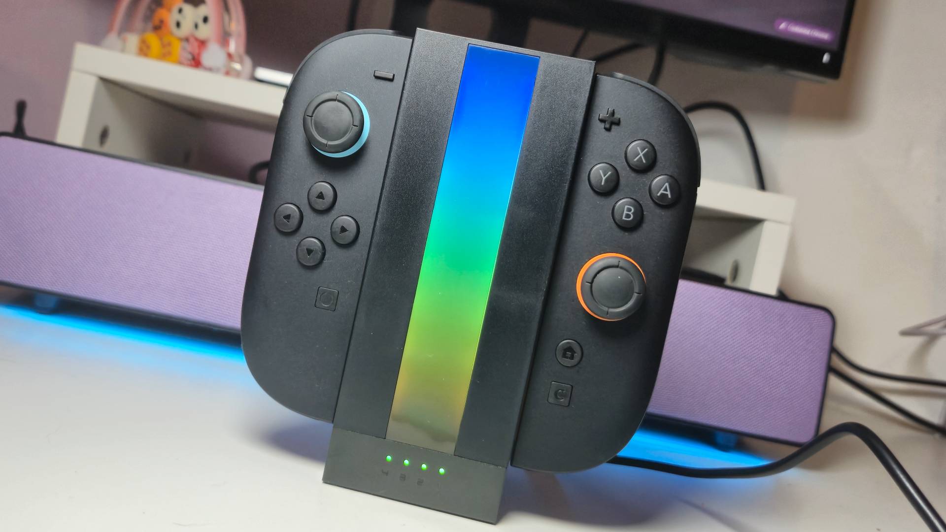 Photo of the Jsaux Energy Flow lit up on a white desk, with two Switch 2 Joy-Con attached.