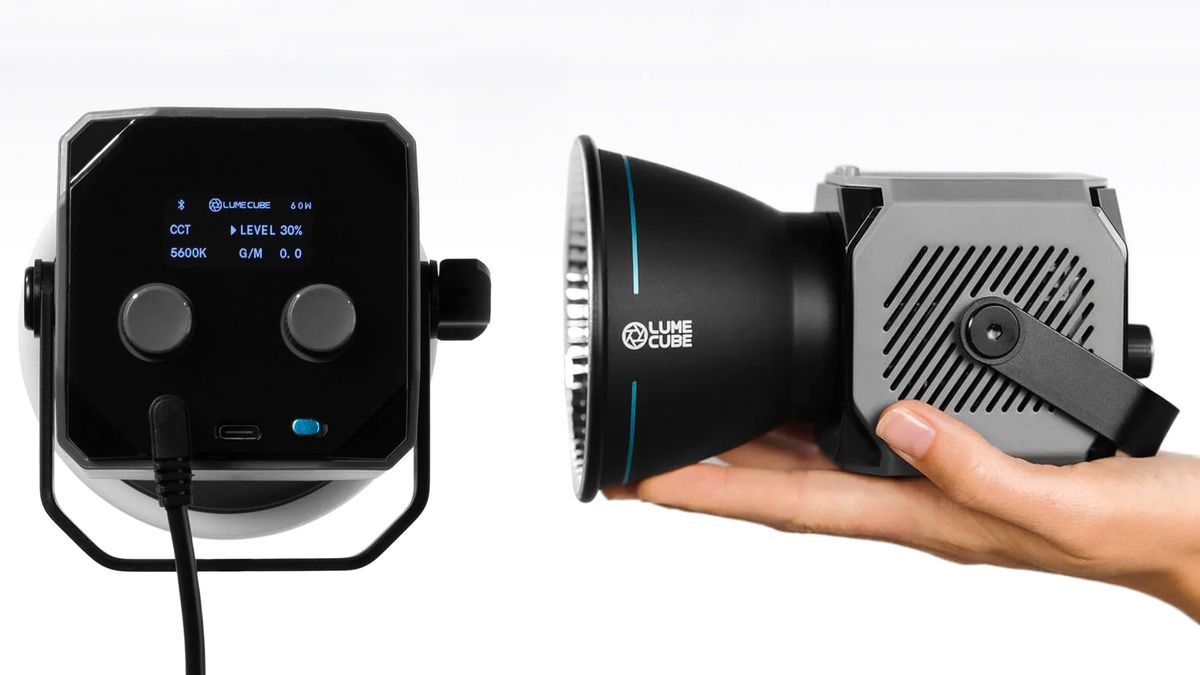 Hand holding Lume Cube XL alongside rear LCD display of Lume Cube XL