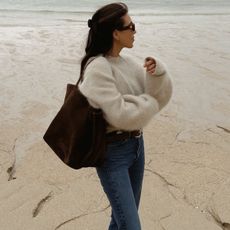 woman in cozy sweater and jeans