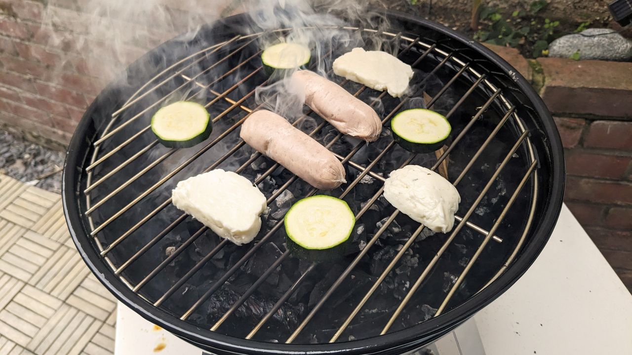Napoleon NK14 Portable Charcoal Kettle Grill being tested in writer's home