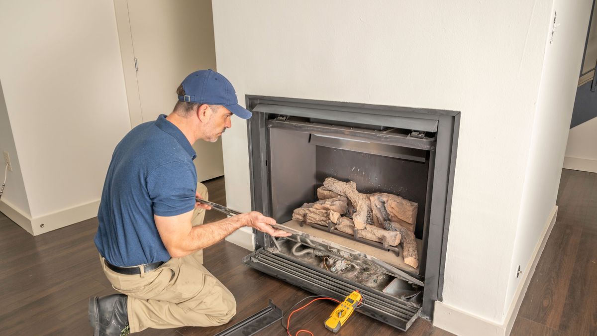 engineer removing gas fire