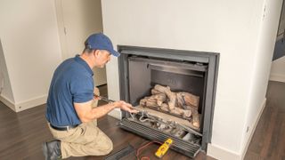 engineer removing gas fire