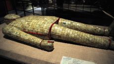 A burial suit comprised of thousands of pieces of jade on display at a museum.