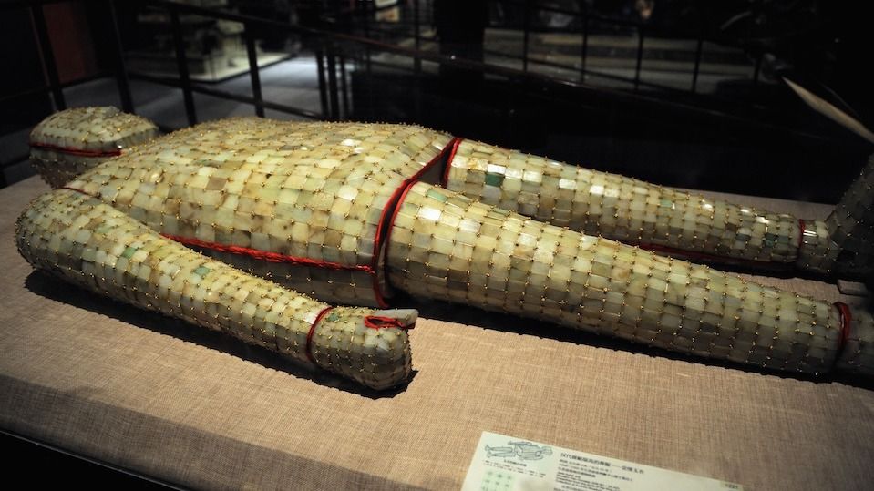 A burial suit comprised of thousands of pieces of jade on display at a museum.