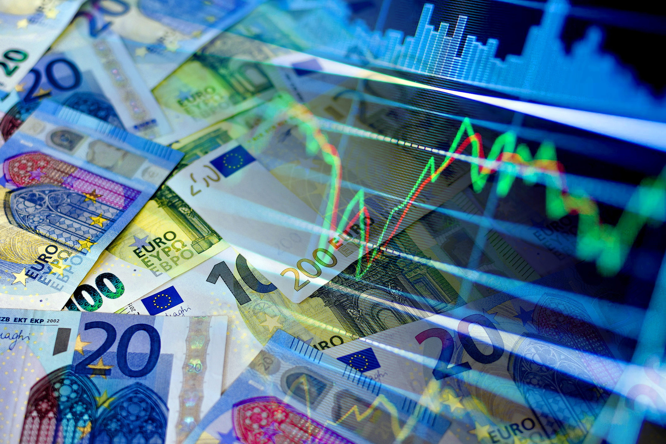 Pile of euro bills overlaid with stock market indicators