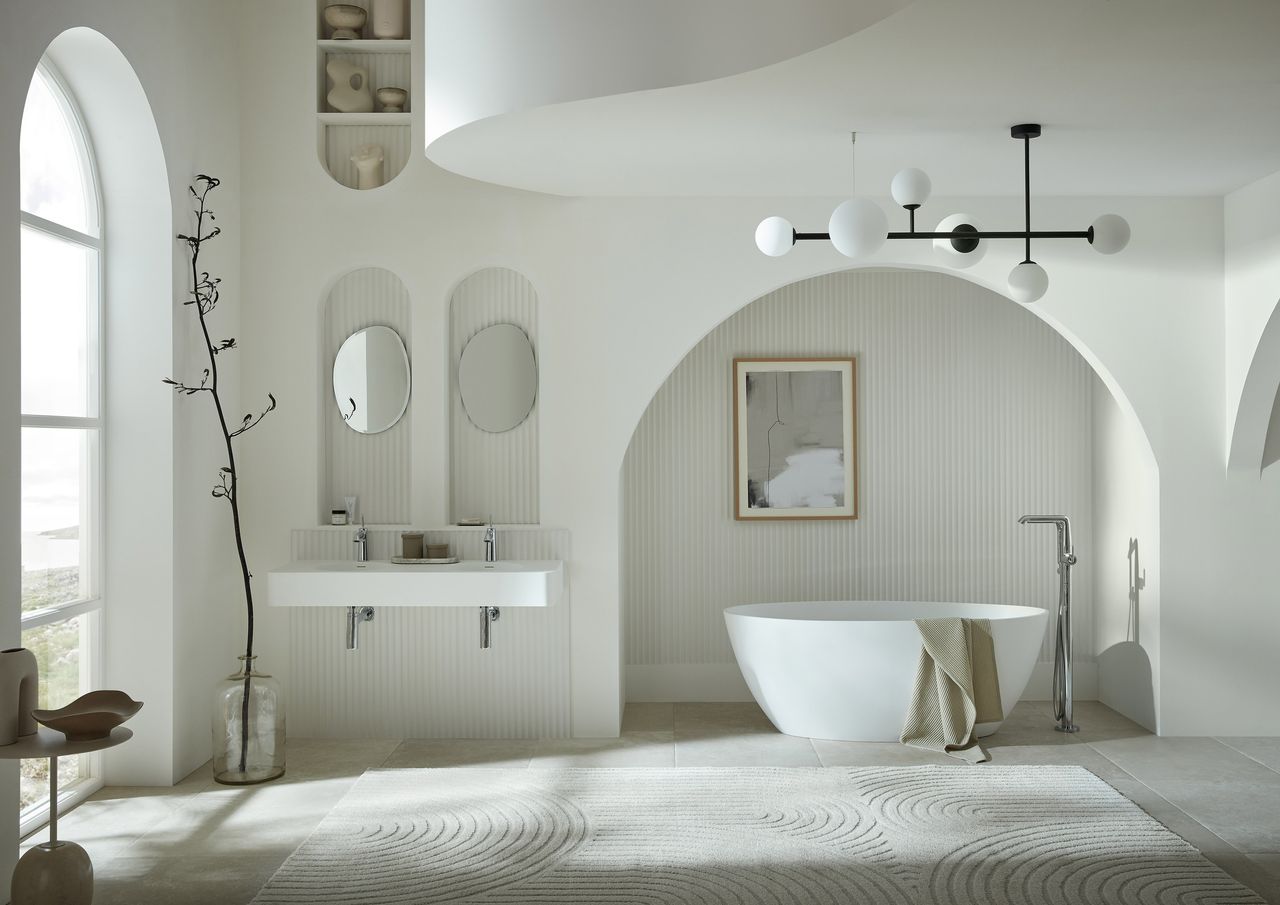 A white bathroom with architectural arches and curved finishes