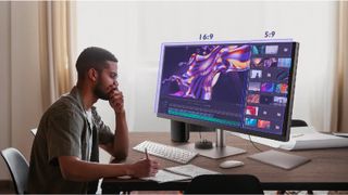 man sitting at a desk looking at one of the best ultrawide monitors