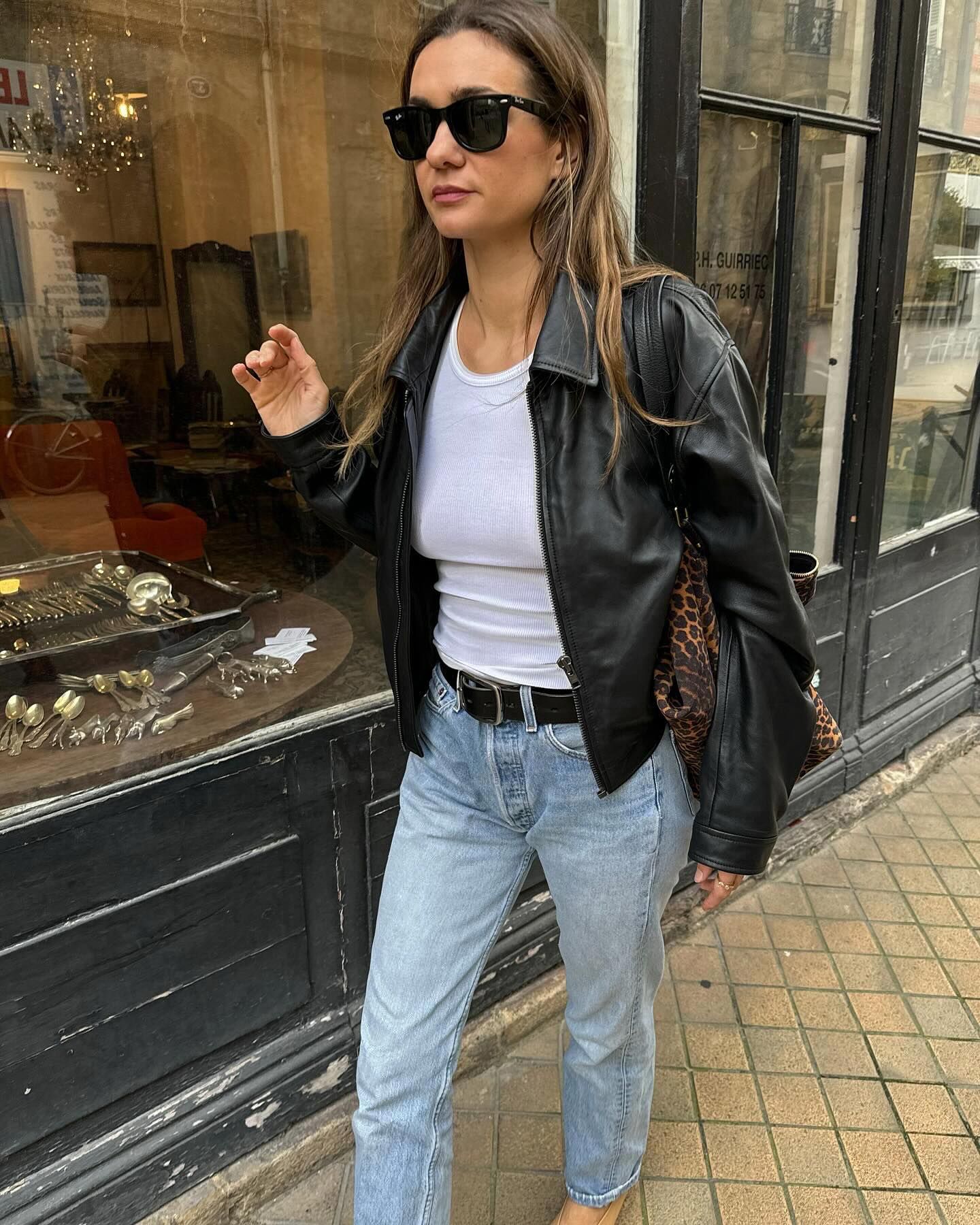 @annelauremais wearing a leather jacket, white tank, and Levi's 501 jeans.