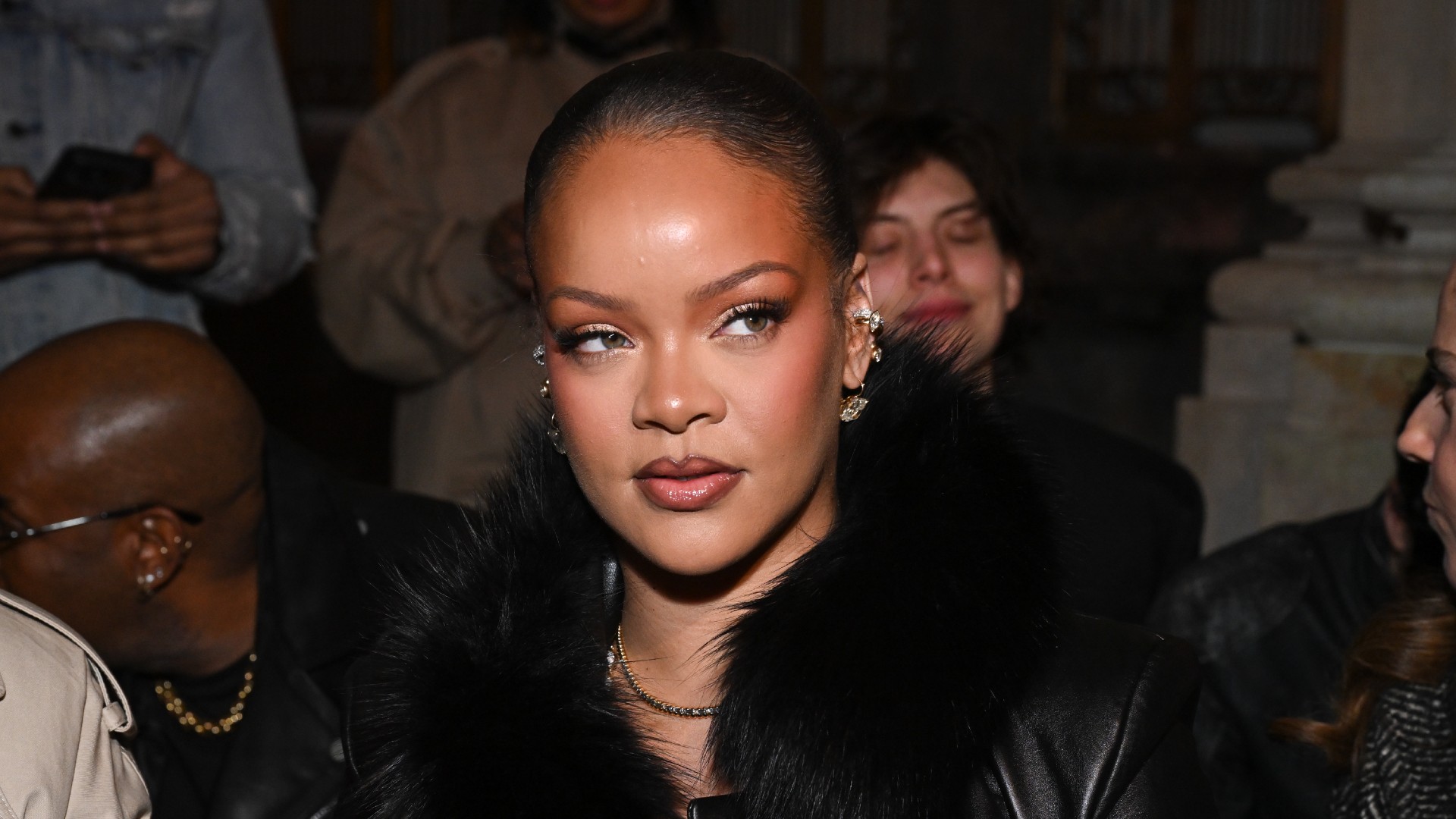 Photo of Rihanna wearing a black jacket at Paris Fashion Week