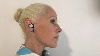Google Pixel Buds Pro worn by a woman on white background