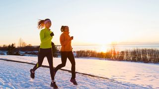 Six ways to keep exercising in winter: image of two women running in snow 