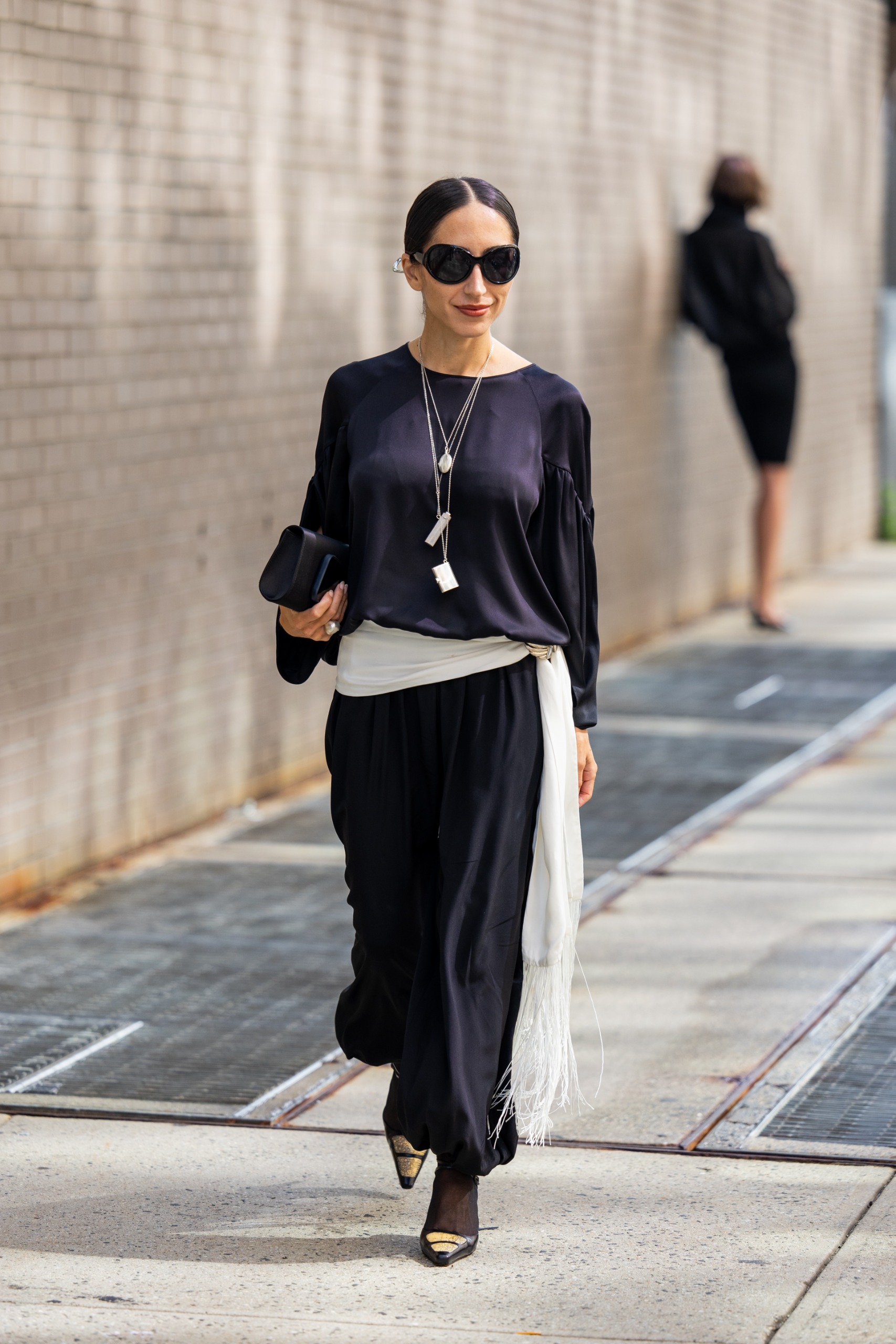 woman in a silky dress tied with a white fringe skirt