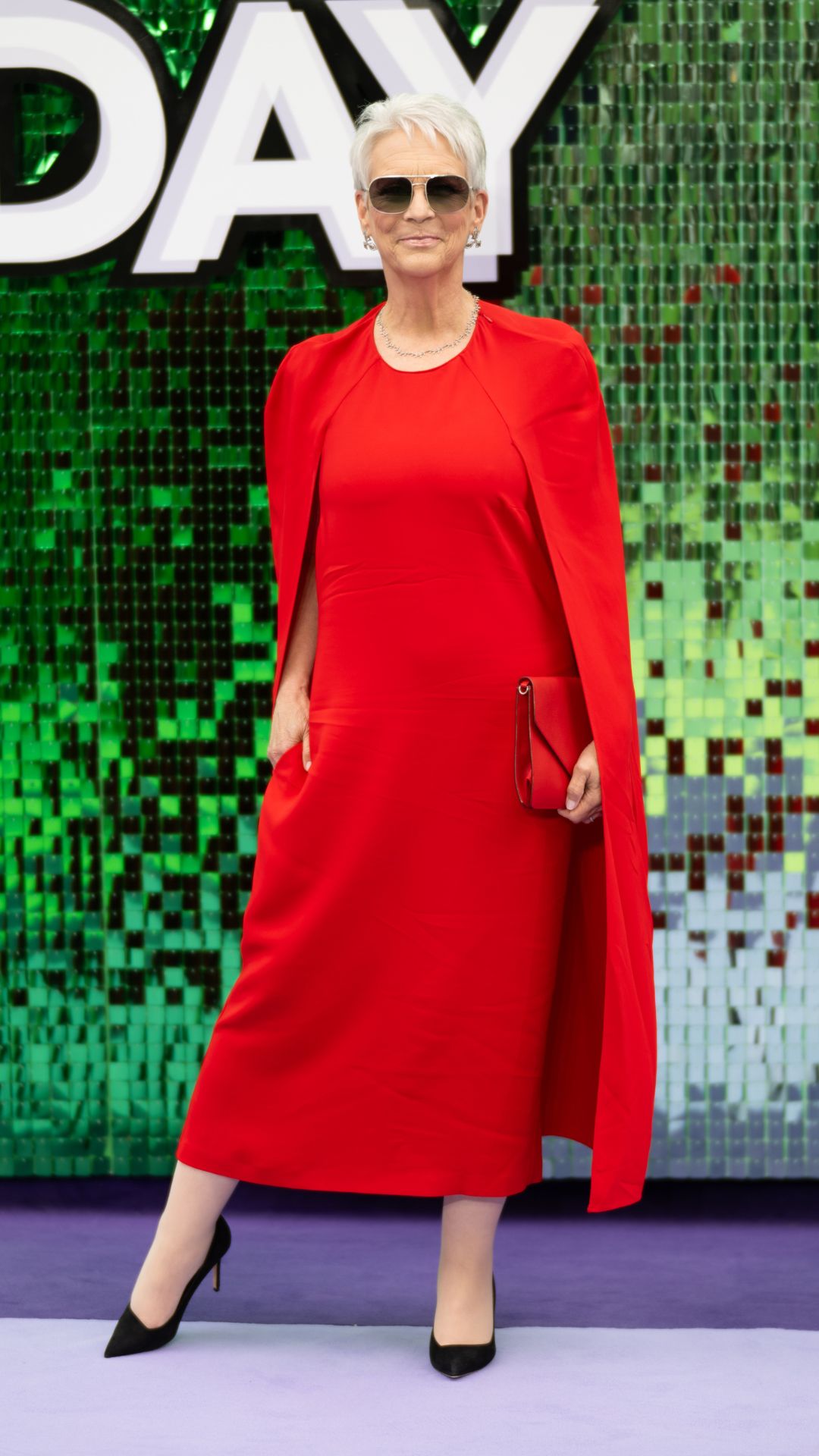 Jamie Lee Curtis wearing red cape dress at the Freakier Friday UK Premiere on July 31, 2025