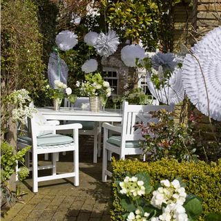 garden area with dining table and flower vase
