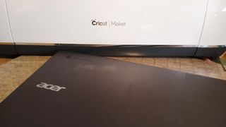The best Chromebooks for Cricut; a photo of a Chromebook with a Cricut Maker
