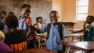 A student says hello to a friend at the start of the school day in Livingstone, Zambia, in this photo by Carina Pilz, from Germany.