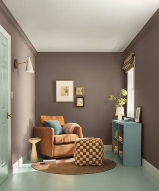 room with brown walls, light blue flooring and orange armchair