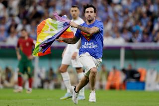 Human rights activist and footballer Mario Ferri invades the pitch during the 2022 World Cup group match between Portugal and Uruguay