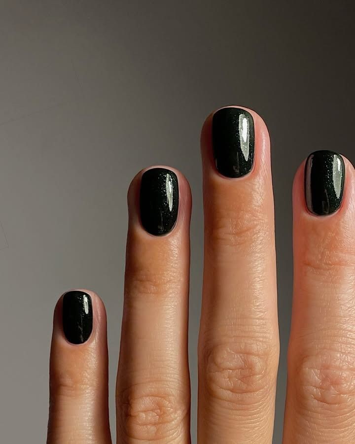Dark green sparkly nails.