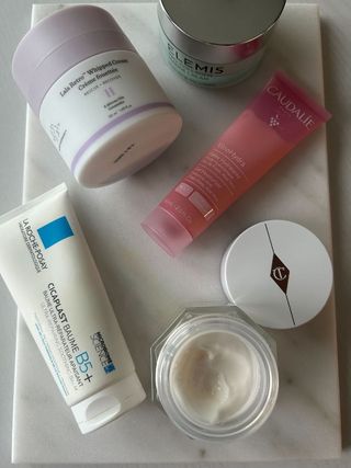 A picture of different moisturisers on a marble table