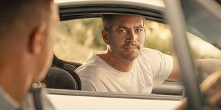 Paul Walker Brian O'Conner looks at Vin Diesel Dominic Toretto in cars Fast and Furious